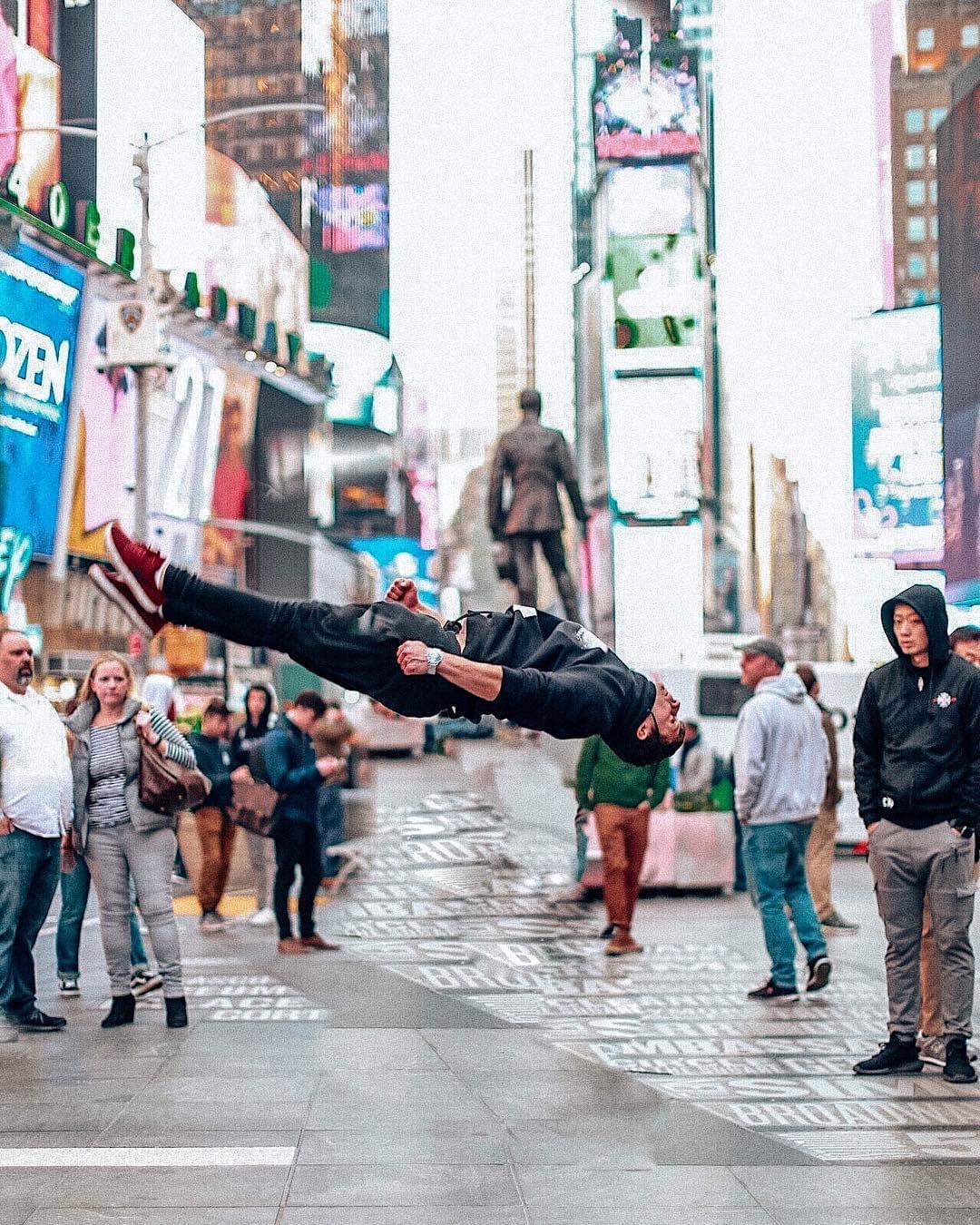 Alex performing a layout flip in Times Square, New York